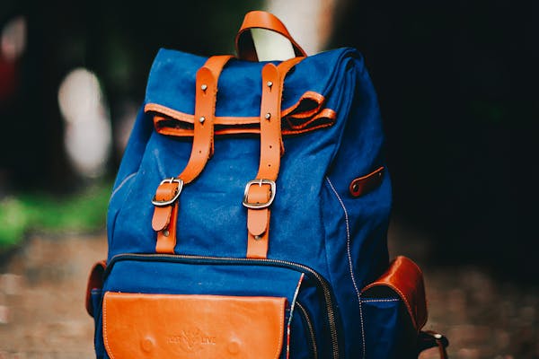 Blue canvas college backpack with leather accents for students