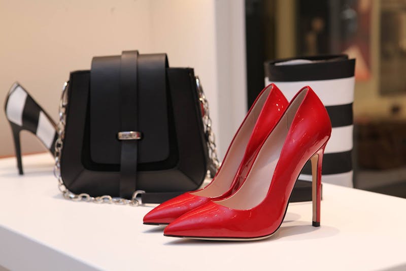 Red stiletto high heels and designer accessories for women
